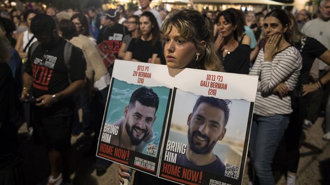 A woman holds a photo of hostages that were kidnapped and taken to the Gaza Strip after the October 7 Hamas' attack. Picture: Amir Levy/Getty Images