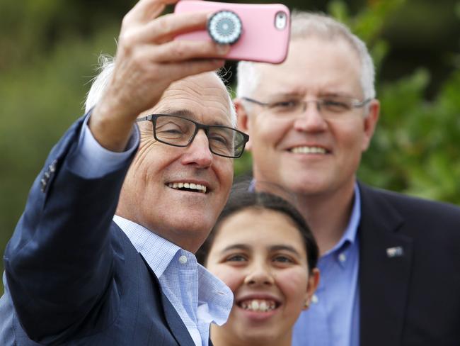 Prime Minister Malcolm Turnbull takes a selfie with Treasurer Scott Morrison and a supporter after a press conference at Kurnell, Sydney, Saturday, April 28, 2018. Mr Turnbull announced the Australian and NSW Governments will together commit $50 million to upgrade the historical site of Captain Cook's landing. (AAP Image/Daniel Munoz) NO ARCHIVING