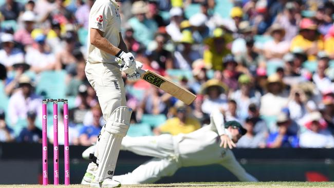 England's Dawid Malan watches as Smith dives to catch him.