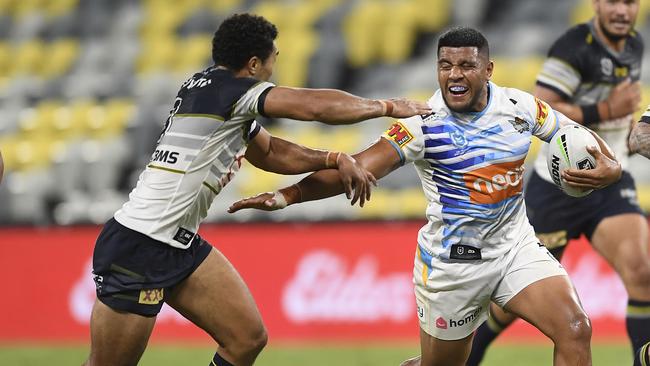 TOWNSVILLE, AUSTRALIA - MAY 29: Moeaki Fotuaika of the Titans gets past Justin O'Neil of the Cowboys during the round three NRL match between the North Queensland Cowboys and the Gold Coast Titans at QCB Stadium on May 29, 2020 in Townsville, Australia. (Photo by Ian Hitchcock/Getty Images)