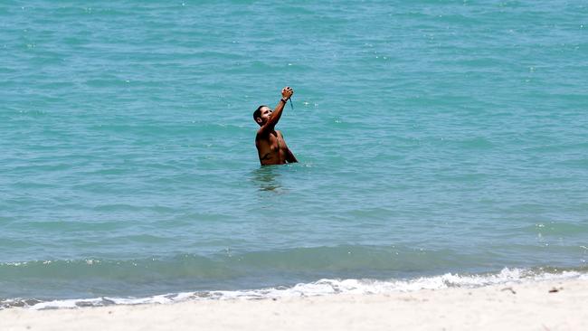 People swimming at Airlie Beach following the shark attack. Picture: NIGEL HALLETT