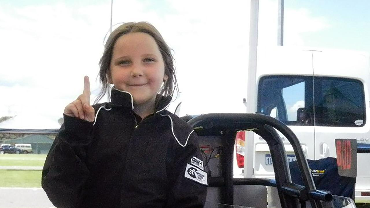 Eight-year-old Anita Board next to her junior dragster racing car. Picture: AFP/Mike Sprlyan/Junior Dragster Australia