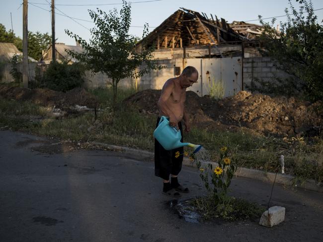 Long-Term Projects - First Prize © Valery Melnikov, Rossiya Segodnya Title: Black Days Of Ukraine Man watering flowers on a street in the destroyed village of Spartak. Story: Ordinary people became victims of the conflict between self-proclaimed republics and the official Ukrainian authorities from 2014 onwards in the region of Donbass. Disaster came into their lives unexpectedly. These people were involved in the military confrontation against their will. They experienced the most terrible things: the death of their friends and relatives, destroyed homes and the ruined lives of thousands of people