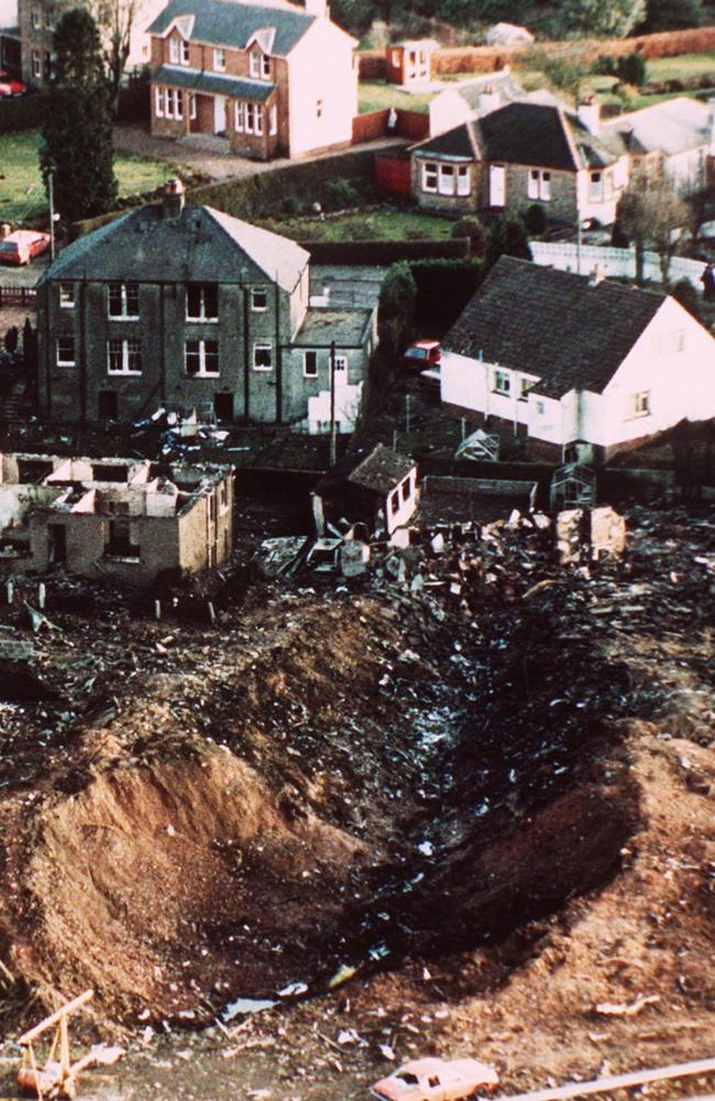 A deep gash in the ground next to destroyed houses caused by the crash of Pan Am Flight 103 through Lockerbie in December 1988.