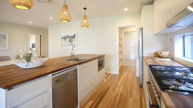 The galley-style kitchen has plenty of storage space and access through to the butler’s pantry.