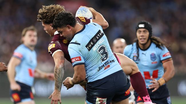 Mitchell tackles Reece Walsh. (Photo by Cameron Spencer/Getty Images)