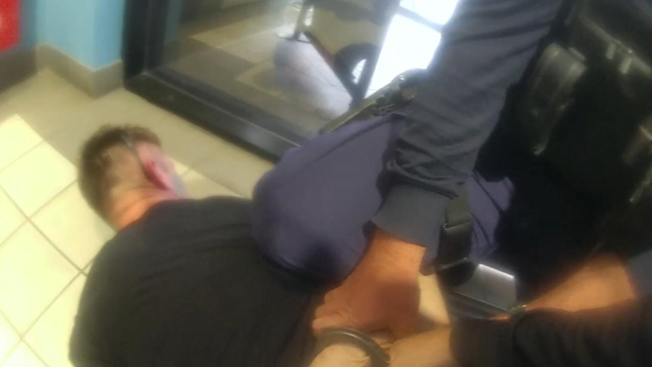 Police restrain and put handcuffs on Hart after he is tasered.