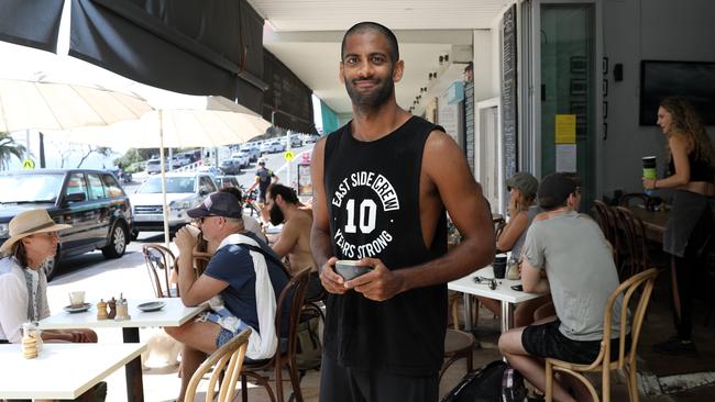 Bronte resident and volunteer lifeguard Rukshan de Silva, 29, managed a quick swim before stopping by Cafe Salina for a sit-down coffee. Picture: Jane Dempster