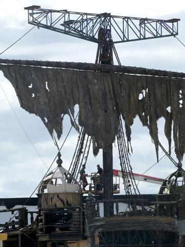 Pirates of the Caribbean on the Coast: Set builders at Helensvale work on creating a battered Black Pearl. Picture: Tim Marsden