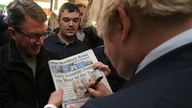 Boris Johnson signs a copy of The Northern Echo for a supporter in the seat of Sedgefield in County Durham. Picture: Getty Images