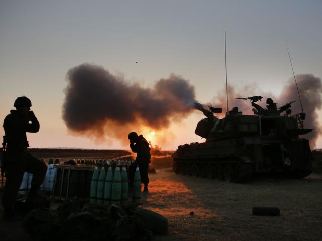 Israeli soldiers fire towards the Gaza Strip on July 21. AFP PHOTO/MENAHEM KAHANA