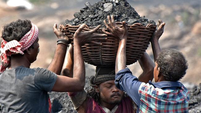 Workers prepare to load coal onto a truck at the Jharia coalfield in Dhanbad in India's Jharkhand state.