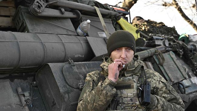 Ukrainian serviceman Petro, 35, stands next to an armoured personnel carrier during an interview near Lyman in the Donetsk region.