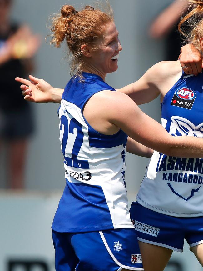 Georgia Nanscawen celebrates a goal with North Melbourne teammates