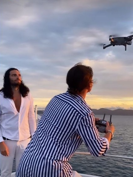 Gold Coast man Ben Morris (left) on board a yacht at Hamilton Island in footage posted online by one of the influencers.