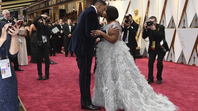 Former NFL star Michael Strahan, left, and Octavia Spencer embrace. Picture: AP