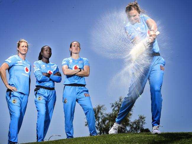 Adelaide Strikers players Sophie Devine, Stafanie Taylor, and Megan Schutt look on as Suzie Bates takes a swing at a water balloon ahead of the start of WBBL05. Picture SARAH REED