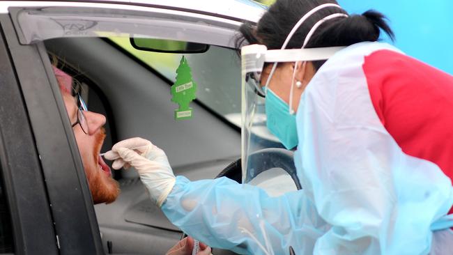 Health care workers take COVID tests of Brisbane residents at a drive in testing site in Herston. Picture: NCA NewsWire / John Gass