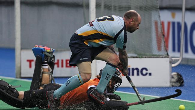 Derwent's James Lambert makes a diving save over NWG's Aaron Jacobson in the 2019 grand final. Picture: LUKE BOWDEN