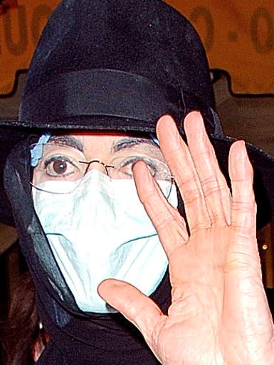 The 50-year-old singer Michael Jackson before his death in his trademark hat and surgeon's mask.