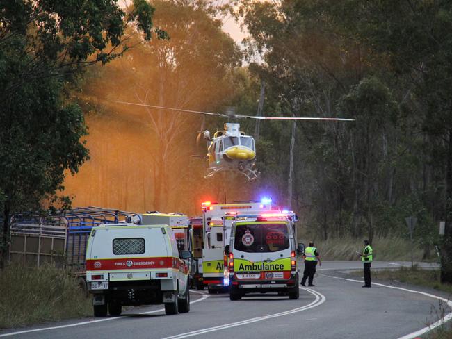 The lifeflight helicopter lands at the scene of a cattle truck crash on the Dawson Highway west of Calliope in which the driver was trapped by the legs for almost 90 minutes.