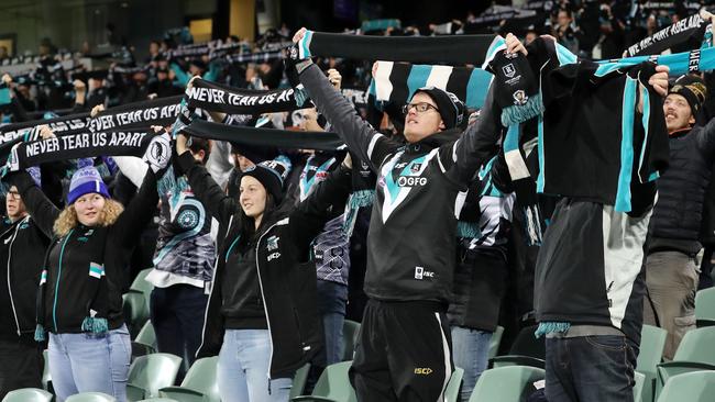 Power fans stand for Never Tear Us Apart before the St Kilda loss. Picture: Sarah Reed