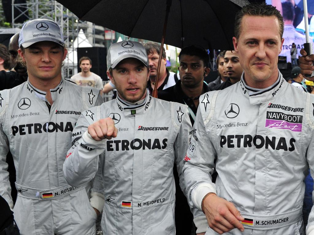 Mercedes team members Michael Schumacher, Nico Rosberg (L) and Nick Heidfeld (C) in 2010.