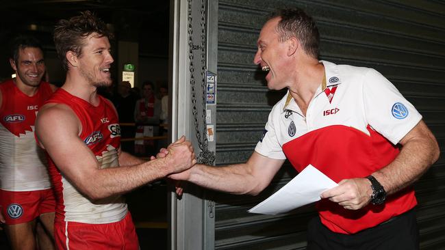 John Longmire congratulates Luke Parker after the siren. Picture: George Salpigtidis