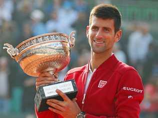 WORLD No.1: Novak Djokovic of Serbia holds the winner's trophy during the victory ceremony for the French Open.