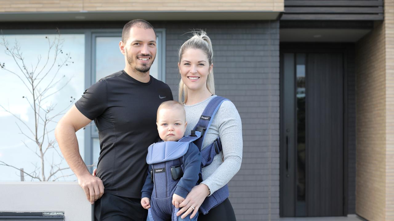 Danielle and James Wallace and their son William outside their new Shawood home in Gledswood Hills. Picture: Supplied