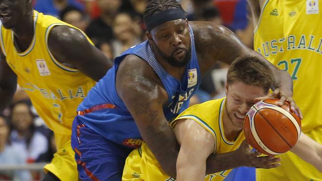 Matthew Dellavedova is fouled by the Philippines’ Andray Blache during the heated game. Picture: AP Photo