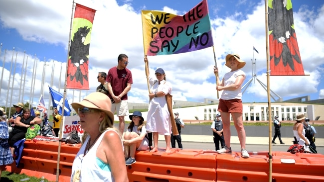 Protesters hold a banner that reads 'we the people say no'. Picture: Tracey Nearmy/Getty Images