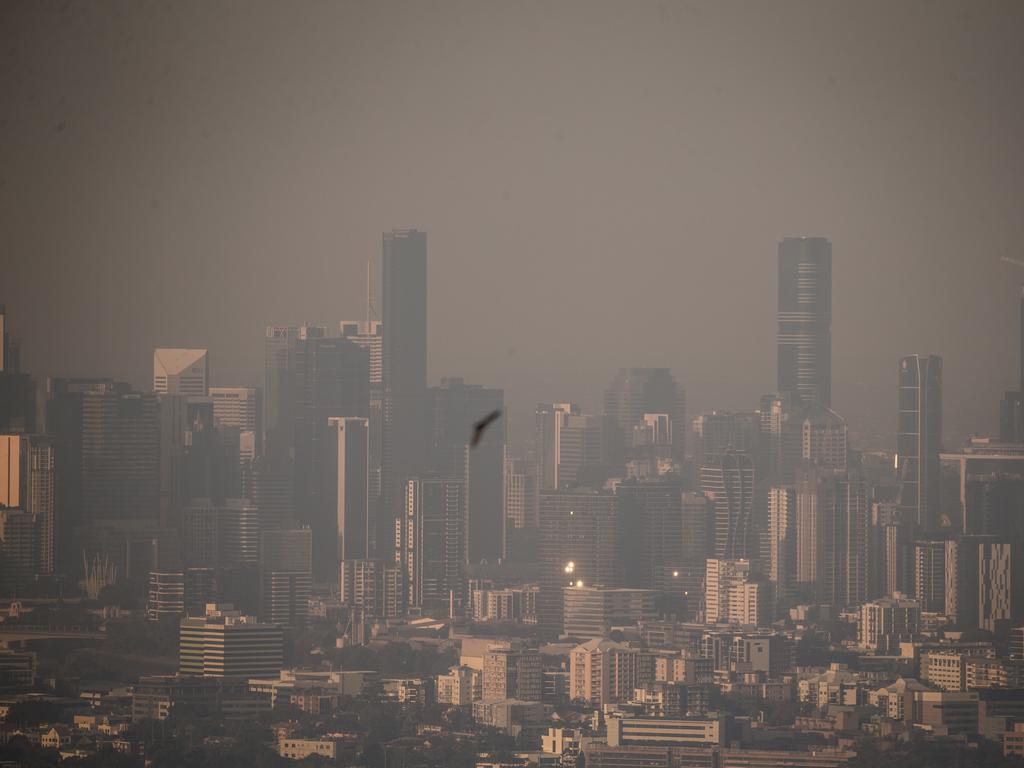 The Brisbane CBD skyline covered by smoke and haze today. Picture: NewsWire / Glenn Campbell