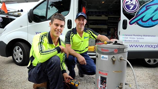 Third year apprentice plumber Brian Fenton works on a hot water system with his boss Mike McEntee from MacPlumb at Black Forrest. Picture: Mark Brake