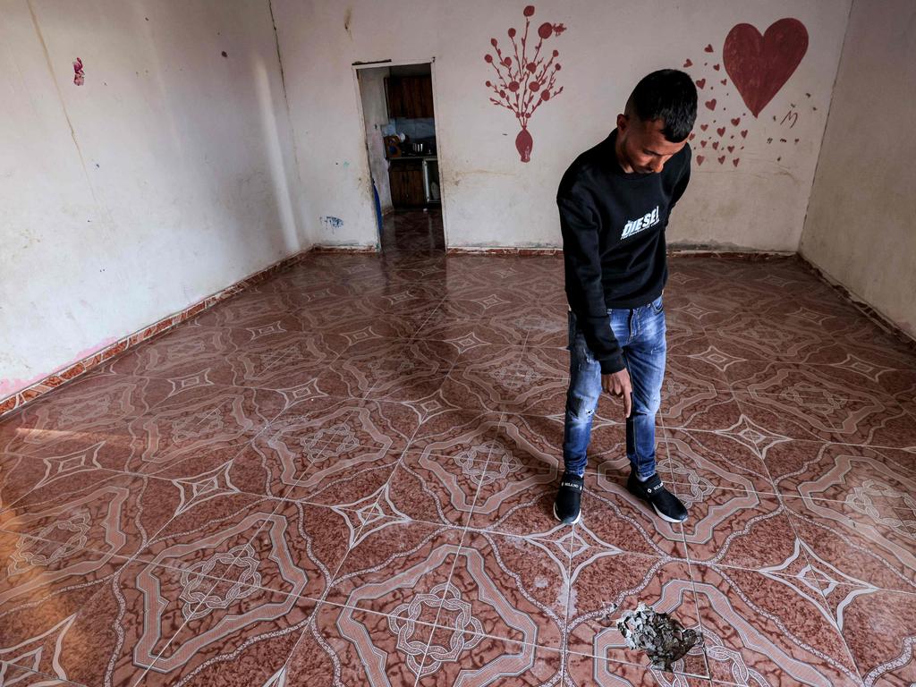 A relative points to a hole in the floor of a building caused by a projectile that struck a seven-year-old Bedouin girl in the southern Negev desert. Iran launched more than 300 drones and missiles towards Israel. Picture: AFP