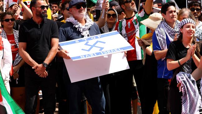 Yazbek holds up a sign with a swastika during the October protest. Picture: NewsWire / Damian Shaw