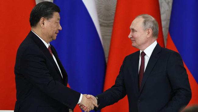 Russian President Vladimir Putin and China's President Xi Jinping shake hands after delivering a joint statement following their talks at the Kremlin. Picture: AFP.