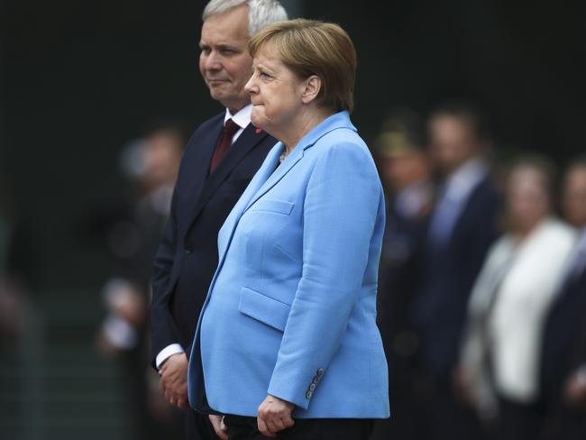 German Chancellor Angela Merkel, right, clenches her fists as she starts shaking again, this time alongside Prime Minister of Finland Antti Rinne in Berlin. Picture: AP