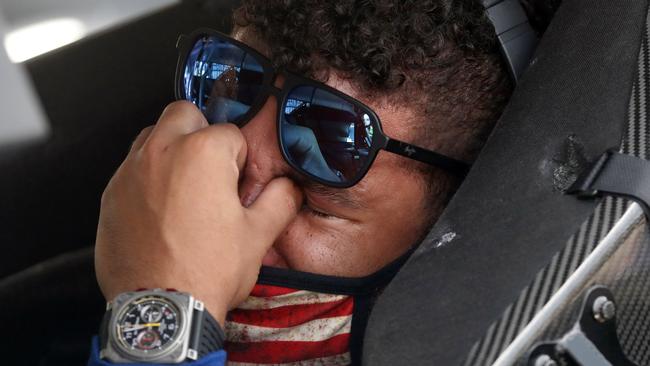 Driver Bubba Wallace is overcome with emotion as he sits in his car prior to the start of the NASCAR Cup Series auto race at the Talladega Superspeedway on Monday. Picture: John Bazemore/AP