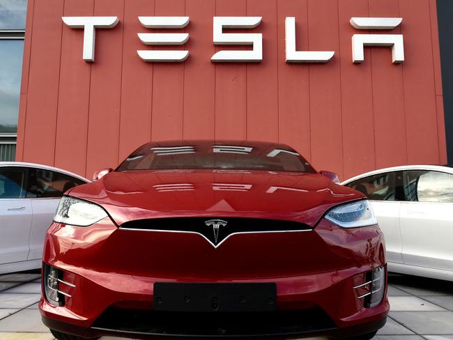 (FILES) In this file photo taken on October 23, 2019 the logo marks the showroom and service center for the US automotive and energy company Tesla in Amsterdam. - Tesla CEO Elon Musk reported late November 19, 2021 that an app problem that was keeping a number of drivers worldwide from using their cars was on the mend after a server issue was resolved. (Photo by JOHN THYS / AFP)