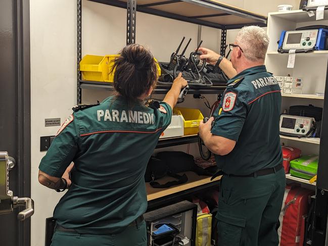 St John Ambulance NT director of ambulance services Andrew Thomas and duty officer Sam Cooper equipping themselves for a busy Friday night shift. Picture: Alex Treacy