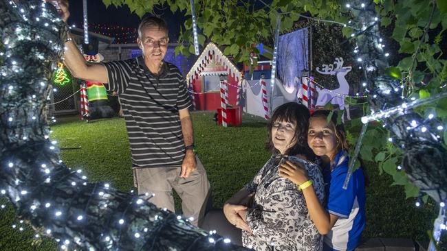 Pete and Sue Black with granddaughter Kira Suey. Christmas lights at 60 Gouldson Drive. Thursday, December 9, 2021. Picture: Nev Madsen.