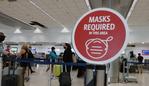 MIAMI, FLORIDA - FEBRUARY 01: A sign reading, 'masks required in this area,' is seen as travelers prepare to check-in for their Delta airlines flight at the Miami International Airport on February 01, 2021 in Miami, Florida. An executive order signed by U.S. President Joe Biden last week mandates mask-wearing on federal property and on public transportation as part of his plan to combat the coronavirus (COVID-19) pandemic.   Joe Raedle/Getty Images/AFP == FOR NEWSPAPERS, INTERNET, TELCOS & TELEVISION USE ONLY ==