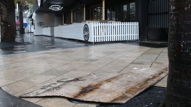 Pieces of hoarding litter Orchid Ave after falling from above Gilleys bar in Surfers Paradise. Picture: Glenn Hampson.