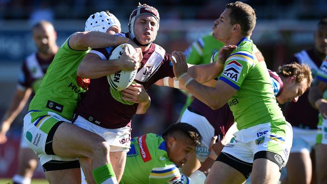 Jamie Buhrer is tackled by Canberra’s Jarrod Croker  and Aidan Sezer at Brookvale Oval on Saturday. Picture: AAP.