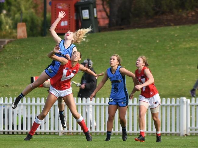 Sturt SANFLW player Zoe Prowse leaps over North Adelaide's Jane Altschwager. Picture: Peter Swan