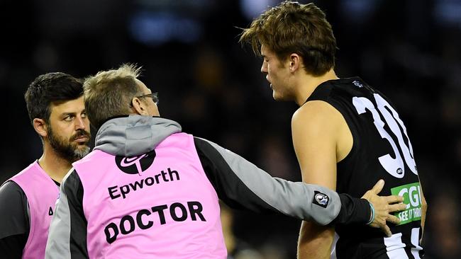 Darcy Moore is taken off for a concussion test at Etihad Stadium in 2017. Picture: AAP