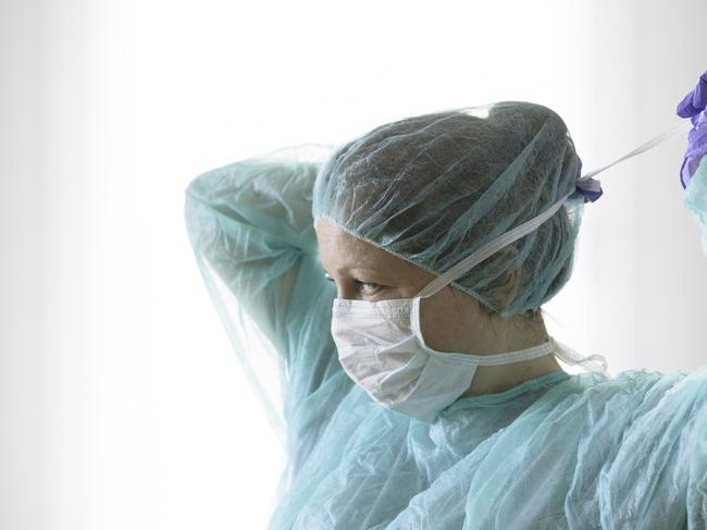 Nurse wearing protective mask and gloves. New coronavirus Covid-19 from China. Female surgeon wearing her surgical mask