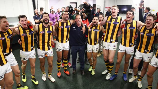 Alastair Clarkson joins in the team song after Hawthorn’s win over Sydney.