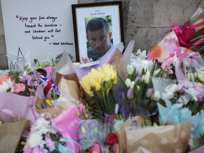 Floral tributes and a photograph of PC Keith Palmer lay outside the Houses of Parliament. Picture: Jack Taylor